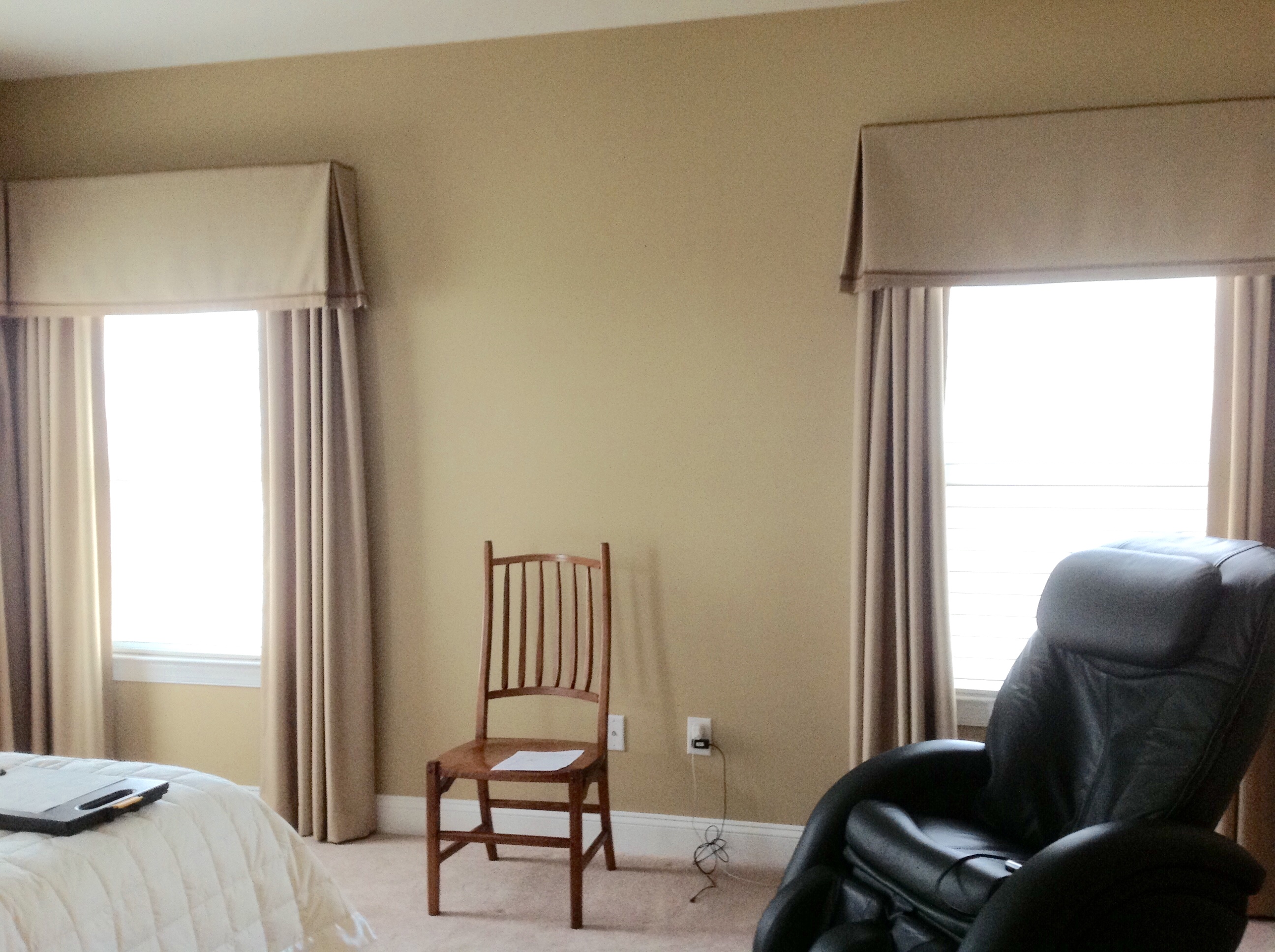 Box pleat valance installed over stationary panels for master bedroom